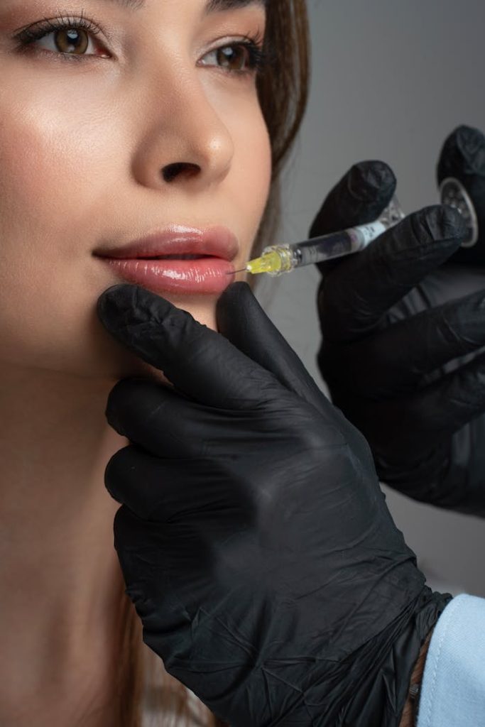 Detailed image of a cosmetic lip injection being administered by a professional.